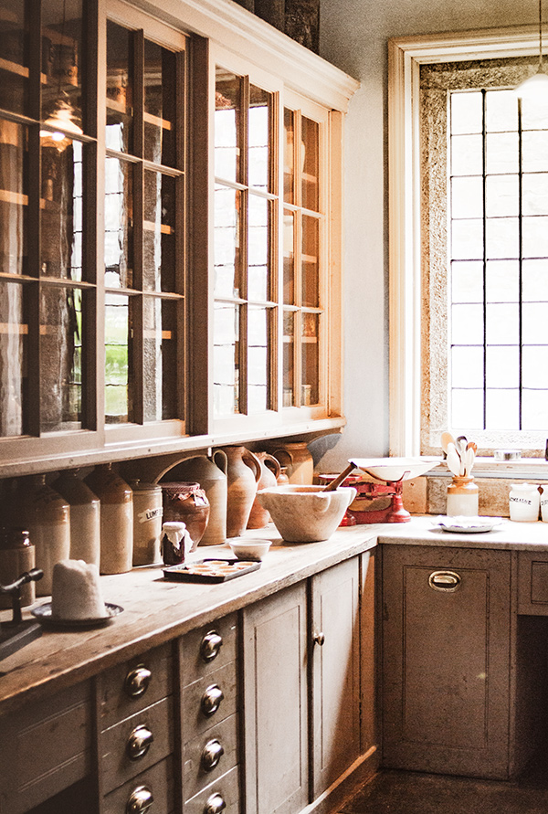 Custom builder Millburn, kitchen corner solid brown lower cabinets and glass front upper cabinets