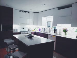 Custom builder Millburn kitchen with glossy white upper cabinets and eggplant purple lower cabinets